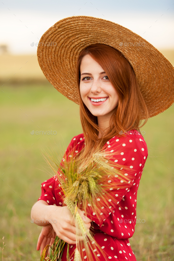 Redhead girl in red dress at wheat field Stock Photo by MassonSimon