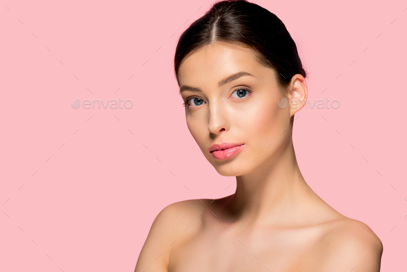 portrait of beautiful naked girl with perfect skin, isolated on pink