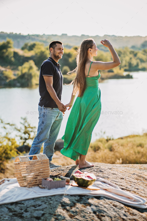 Cheap Vacations for Couples, Candid couple in love holding hands on