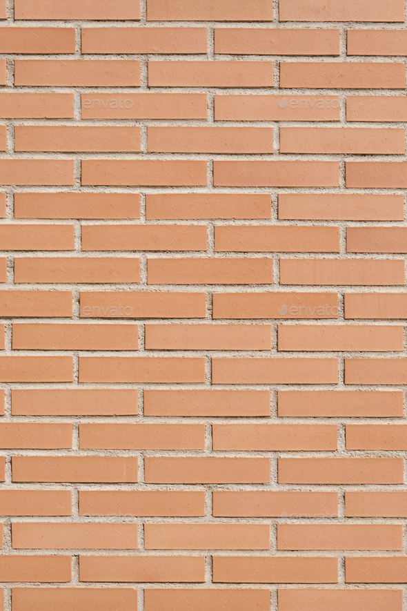 Brick wall with clean orange bricks. Background vertical texture. Stock