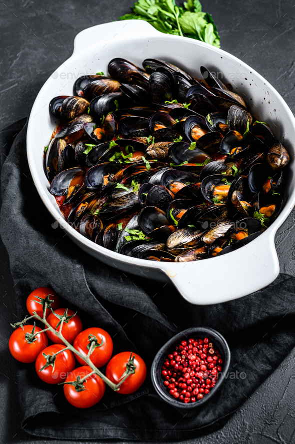 Mussels in tomato sauce with parsley and herbes in Italian style. Black