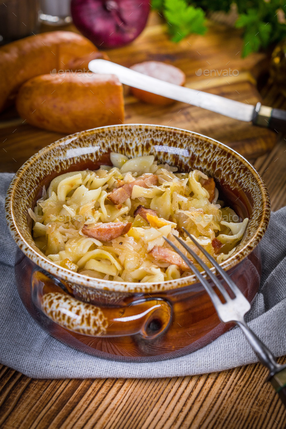 Pasta with sauerkraut and sausage. Stock Photo by foto_pstryki PhotoDune