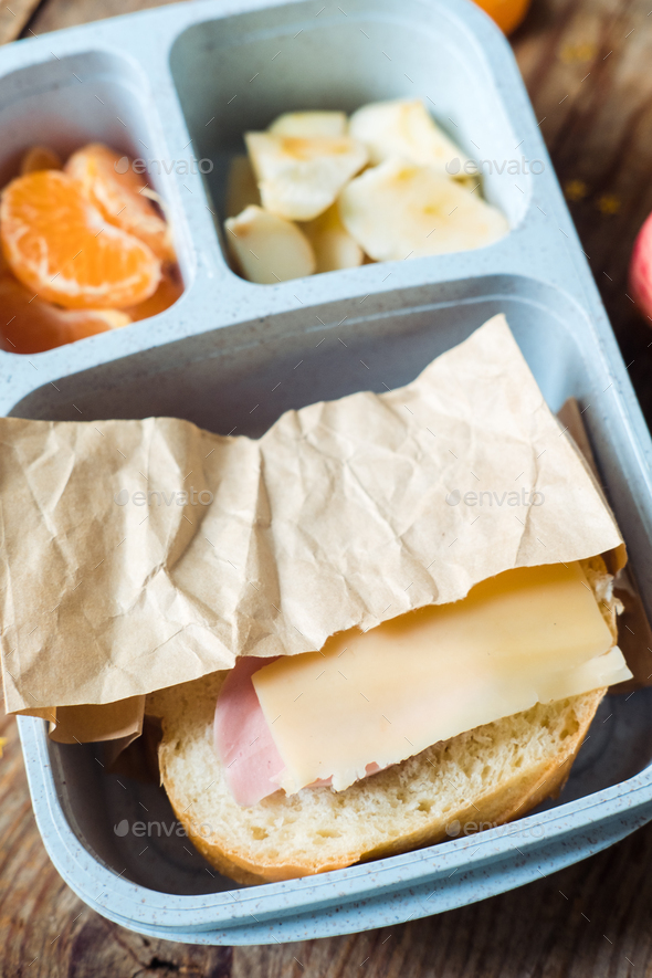 Ham and cheese sandwich in school lunchbox, top view Stock Photo by