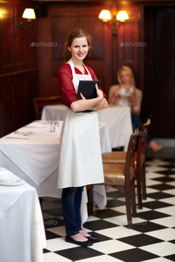 How may I serve you. Cute young waitress standing waiting to serve a