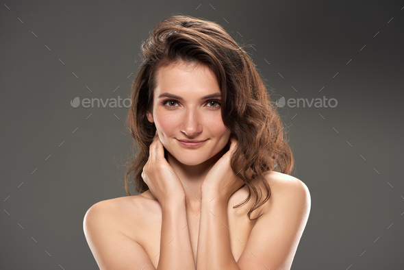 beautiful naked girl with clean skin, isolated on grey Stock Photo by