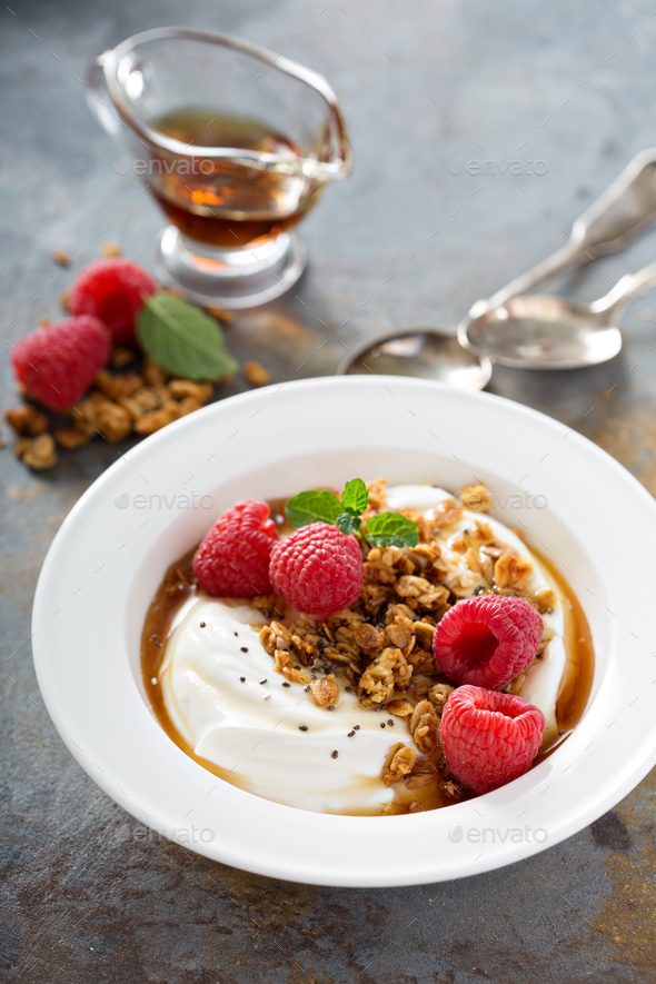 Yogurt bowl with raspberry and maple syrup Stock Photo by fahrwasser