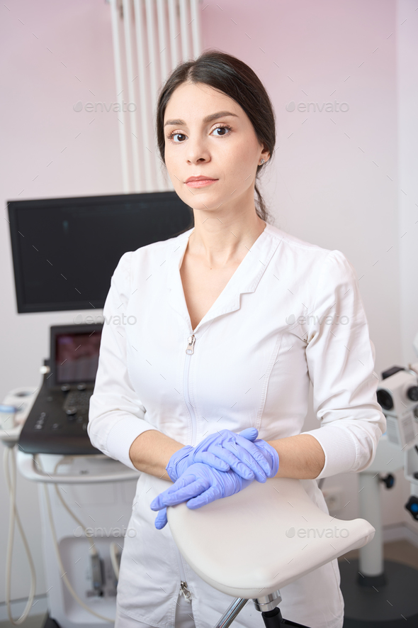 Female gynecologist is standing in the clinic office Stock Photo by