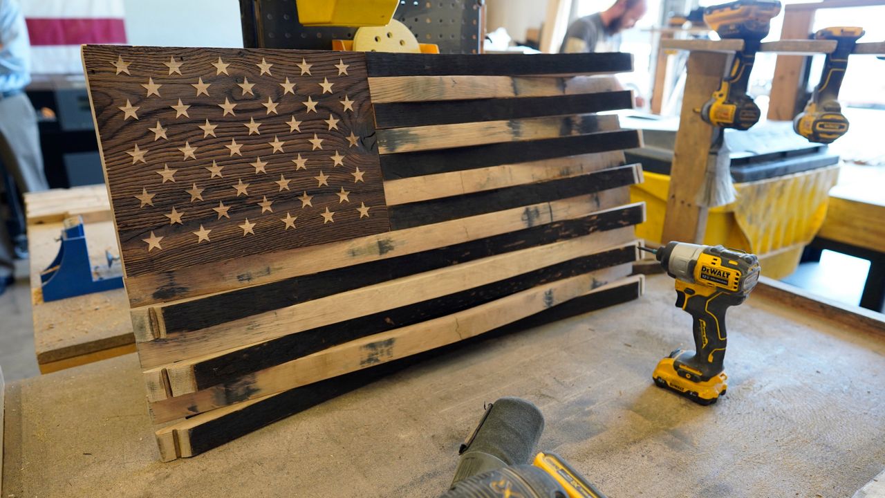 Booming business Veterans build wooden flags