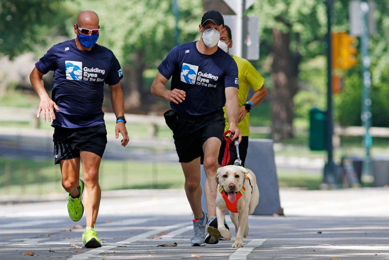 Guide dogs helping blind runners stay fit despite pandemic