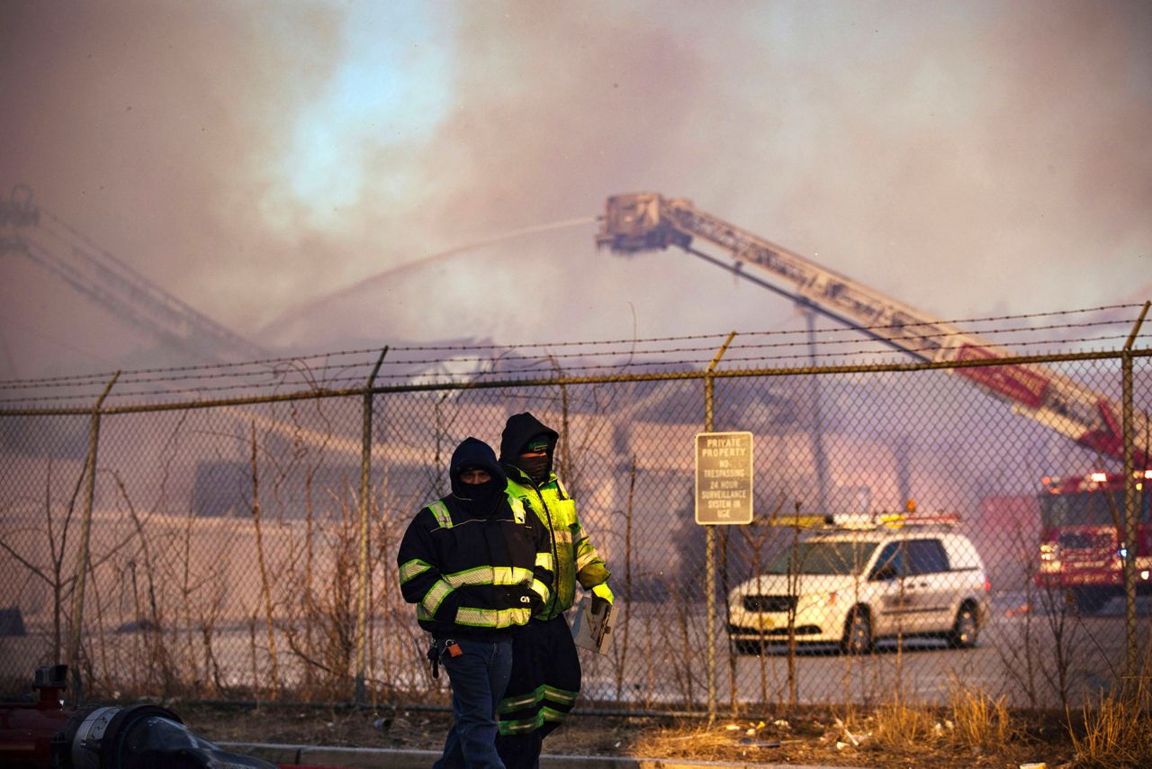 Crews battle flames, cold, wind in huge recycling plant fire