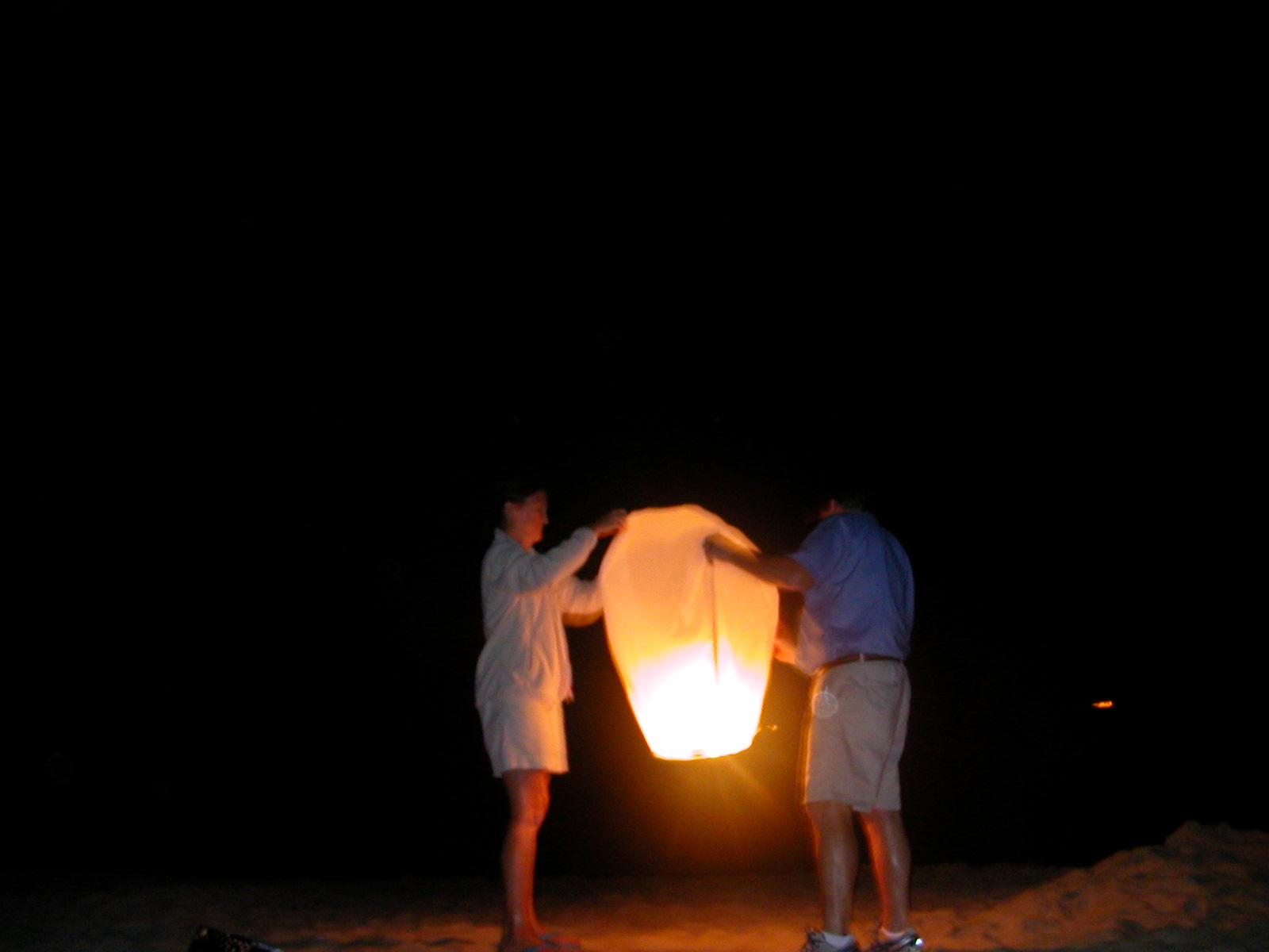 Sky Lanterns at night, on the beach The Sandcastle Lady