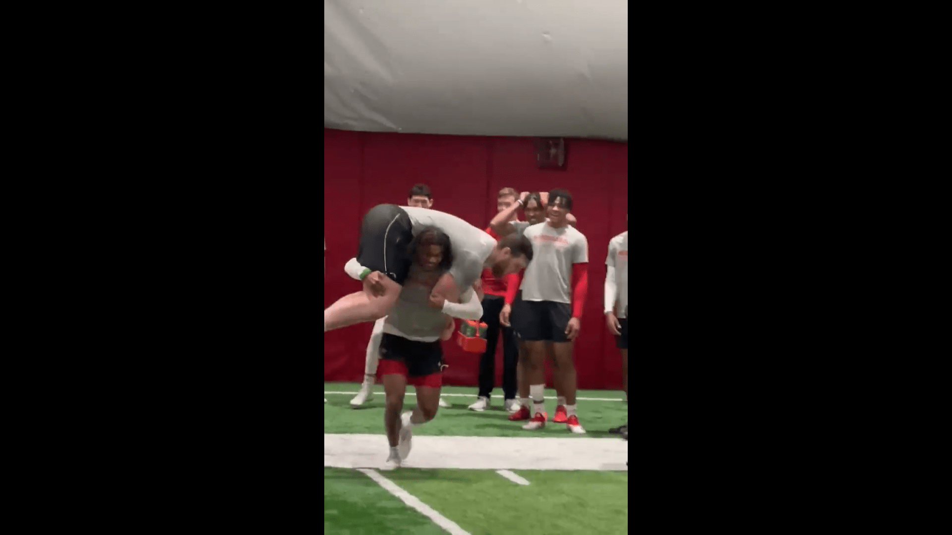 Omar Brown, Nebraska DB, carries 300pound teammate Teddy Prochazka