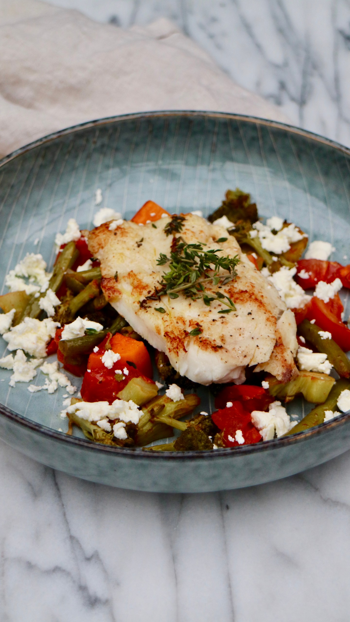 Fried Sheepshead fish on a green and red salad with Feta cheese