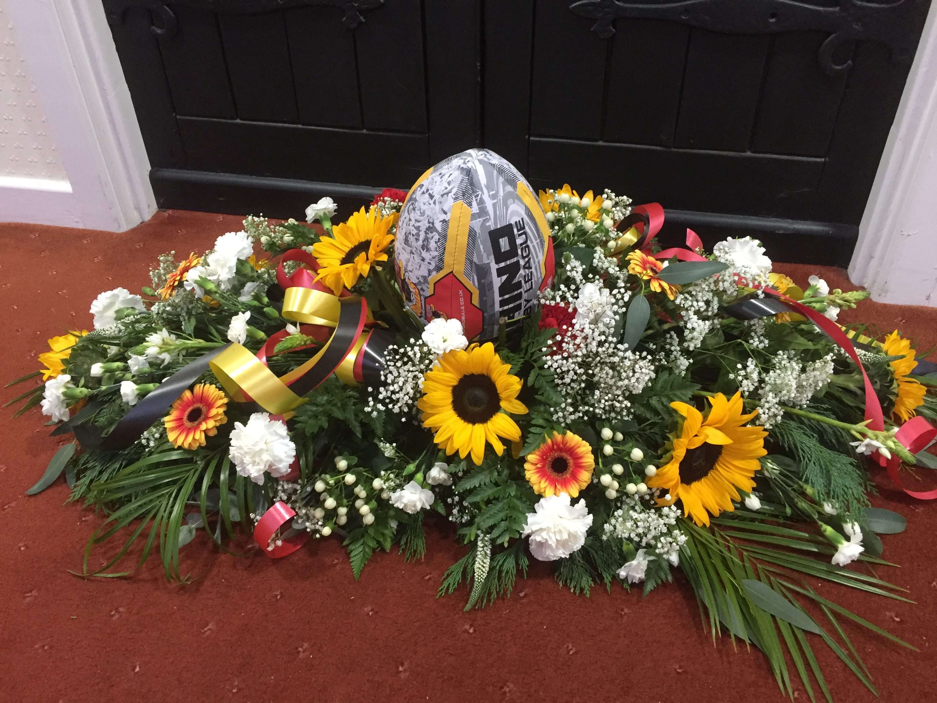 BfdBullsRugbyBallCoffinTopSpray Scentiments Flowers