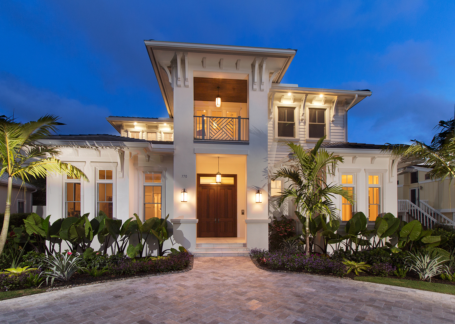 South Florida Design Front elevation at dusk of a tan contemporary 2
