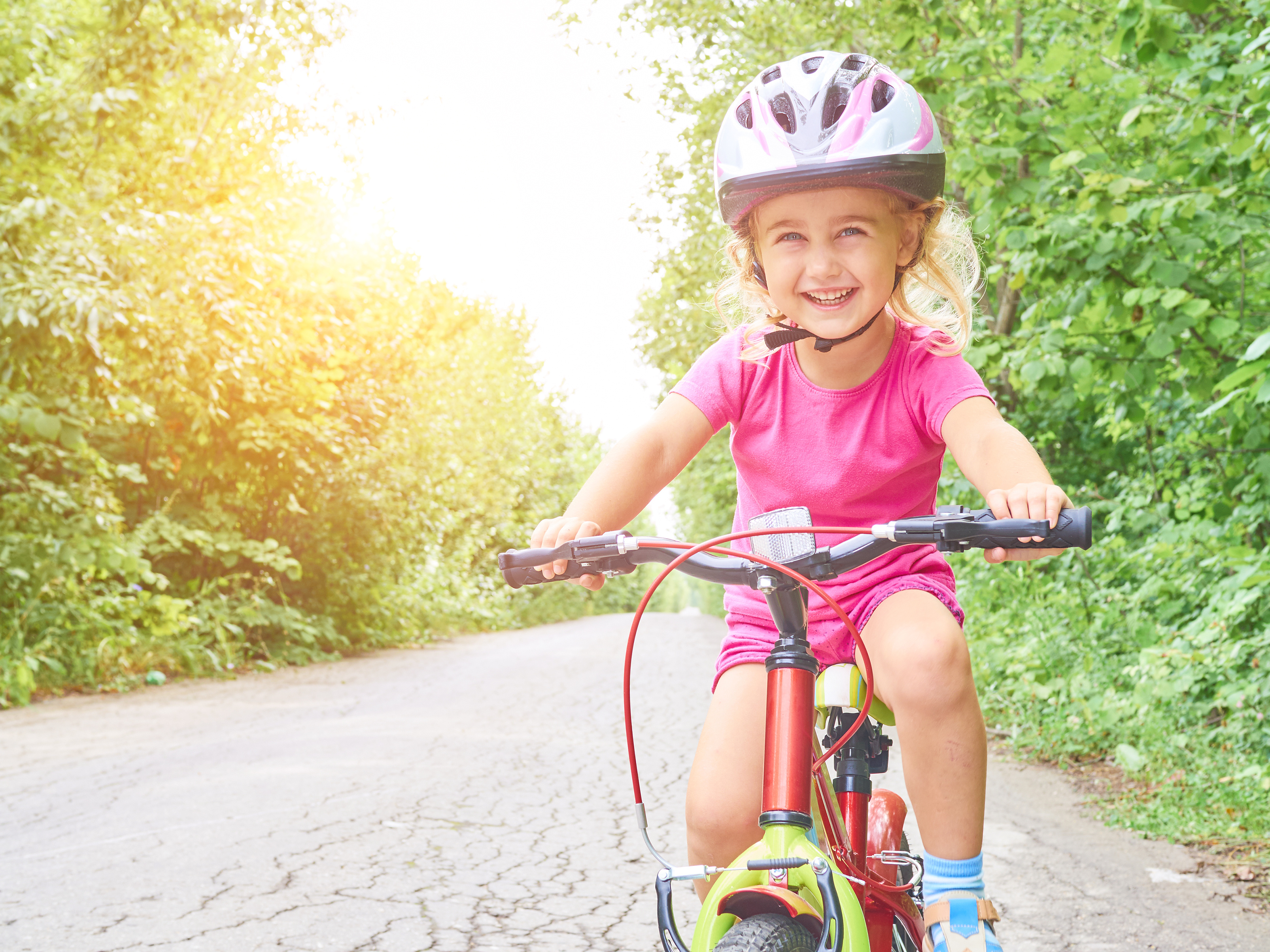 Happy child riding a bike in outdoor. Shaping