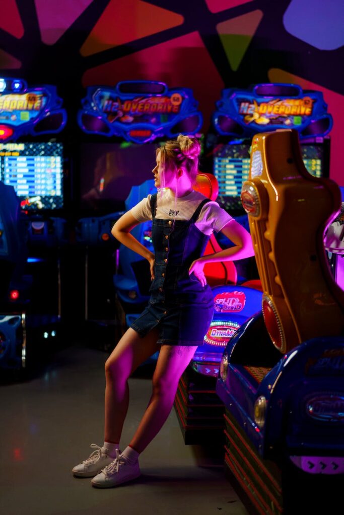 a woman wearing a jumper in an arcade