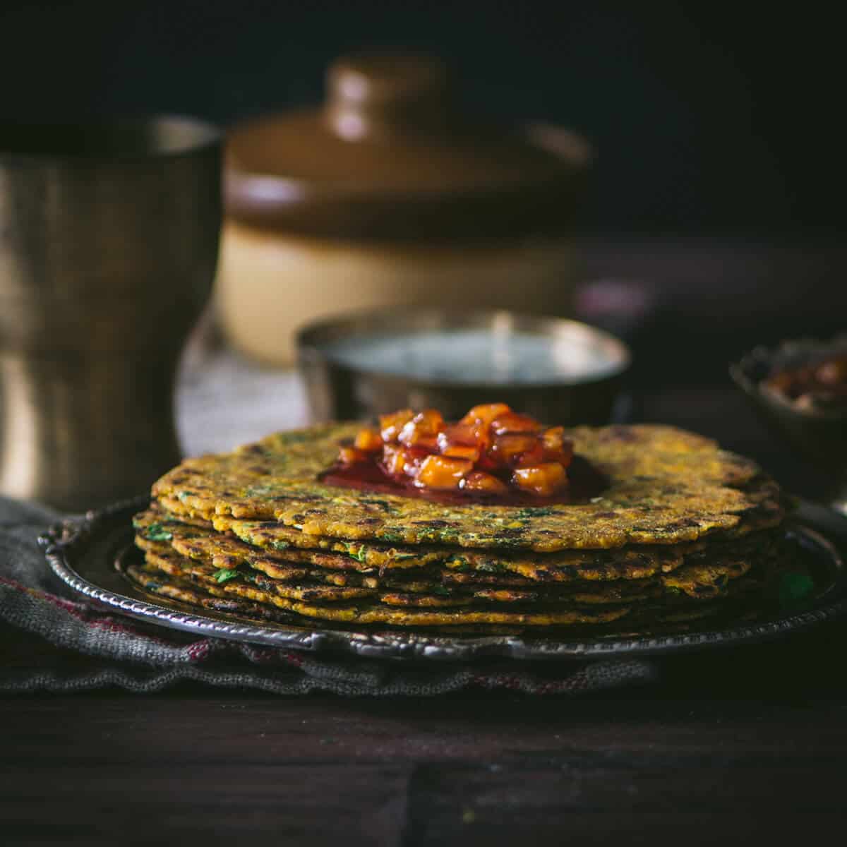 Methi thepla served with chundo on top and yogurt on the side