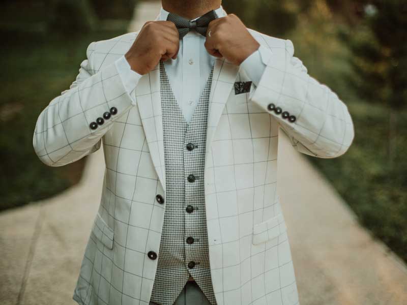 Man Adjusting Bow Tie Simon's Formal Wear