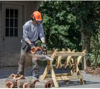 Picture of a man using a Husqvarna 16 Inch 130 Gas Chainsaw