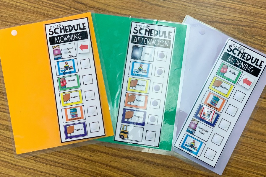 This is a photo of the mobile visual schedules I use in my room. One is yellow, one is green, and one is light purple.