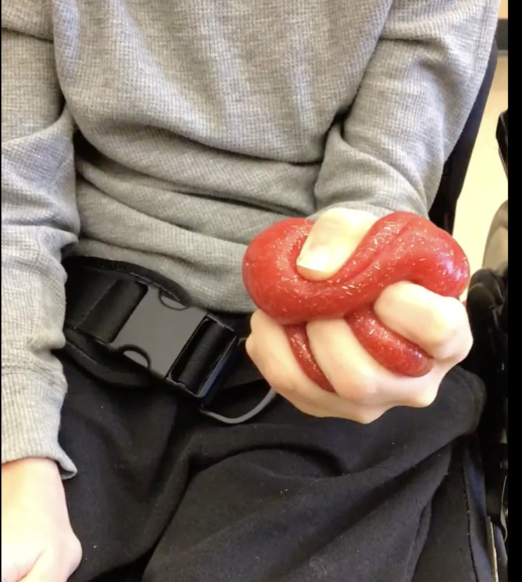 student squeezing Crazy Aaron's Thinking Putty