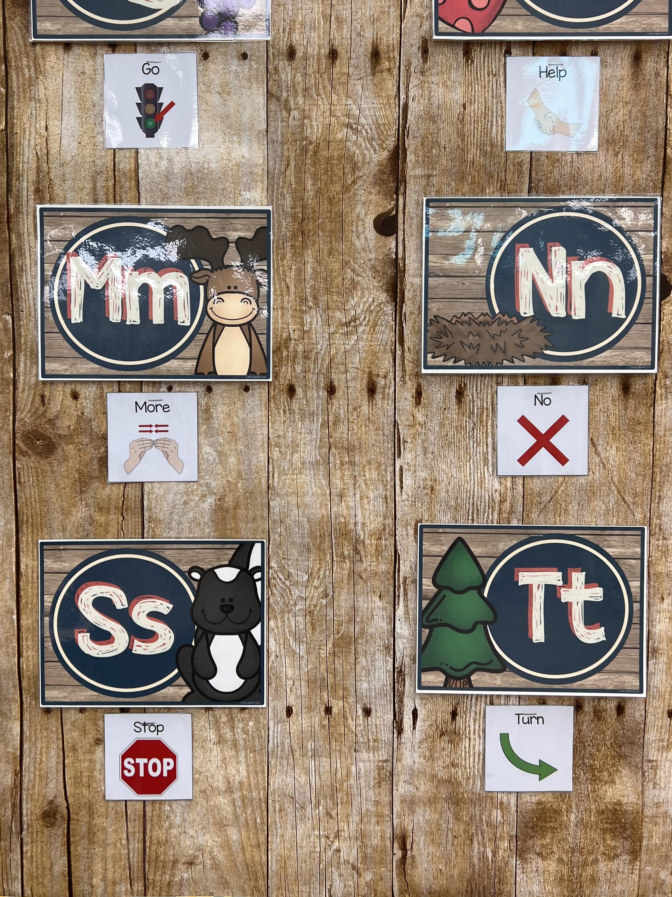 Core words in the classroom on the word wall including the words go, help, more, no, stop and turn.