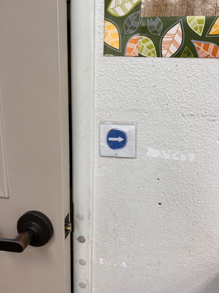 The core word “go” hanging by the door in the classroom.