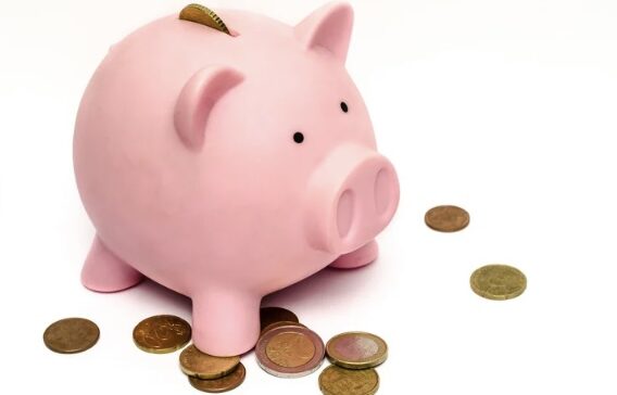 Pink piggy bank with gold coins