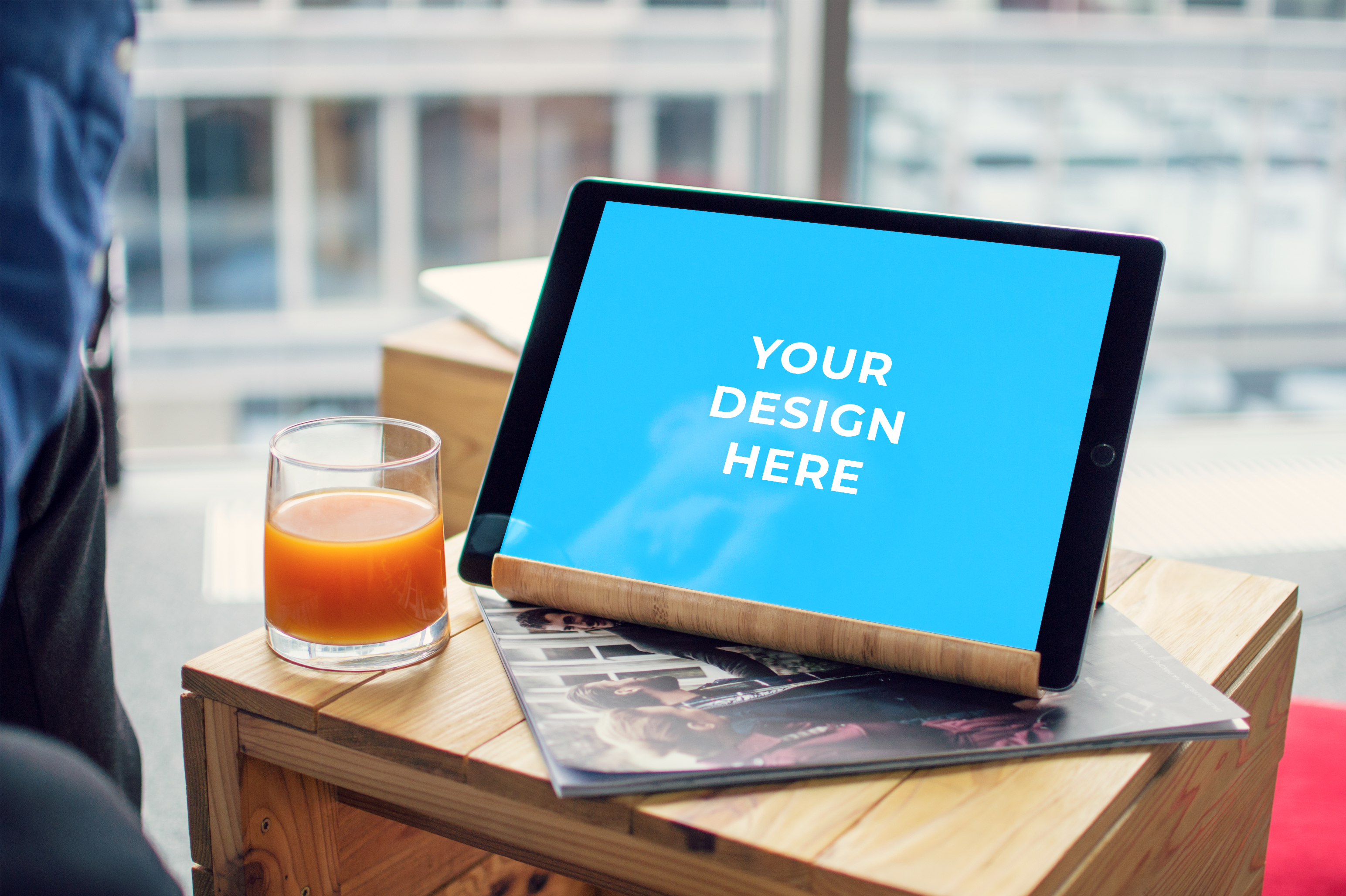Free iPad Pro on a wooden table with a camera Mockup generator