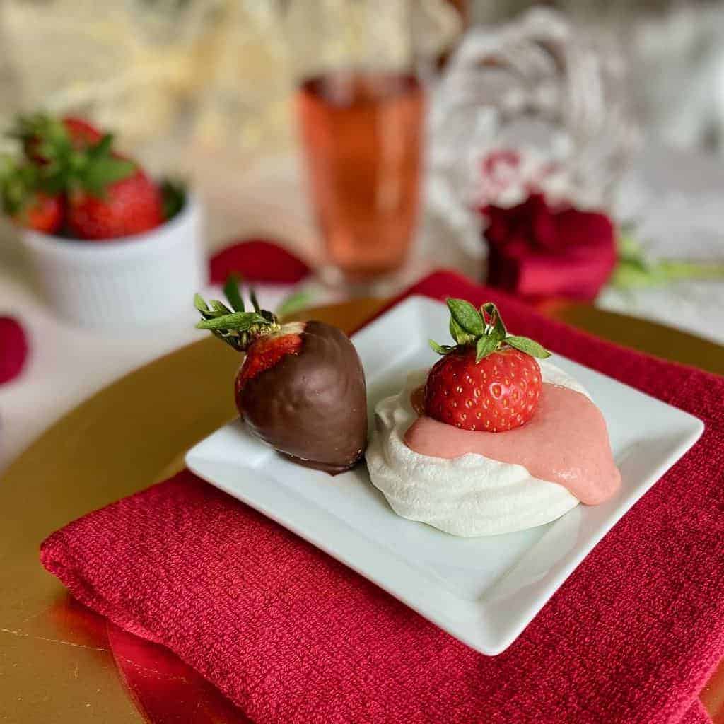 Mini pavlova topped with strawberry curd.