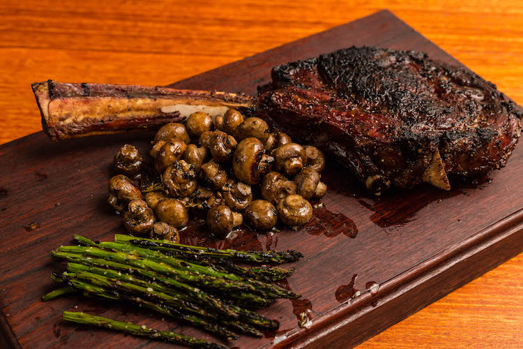 Reverse Seared Tomahawk Steak with garlic butter mushrooms and grilled asparagus