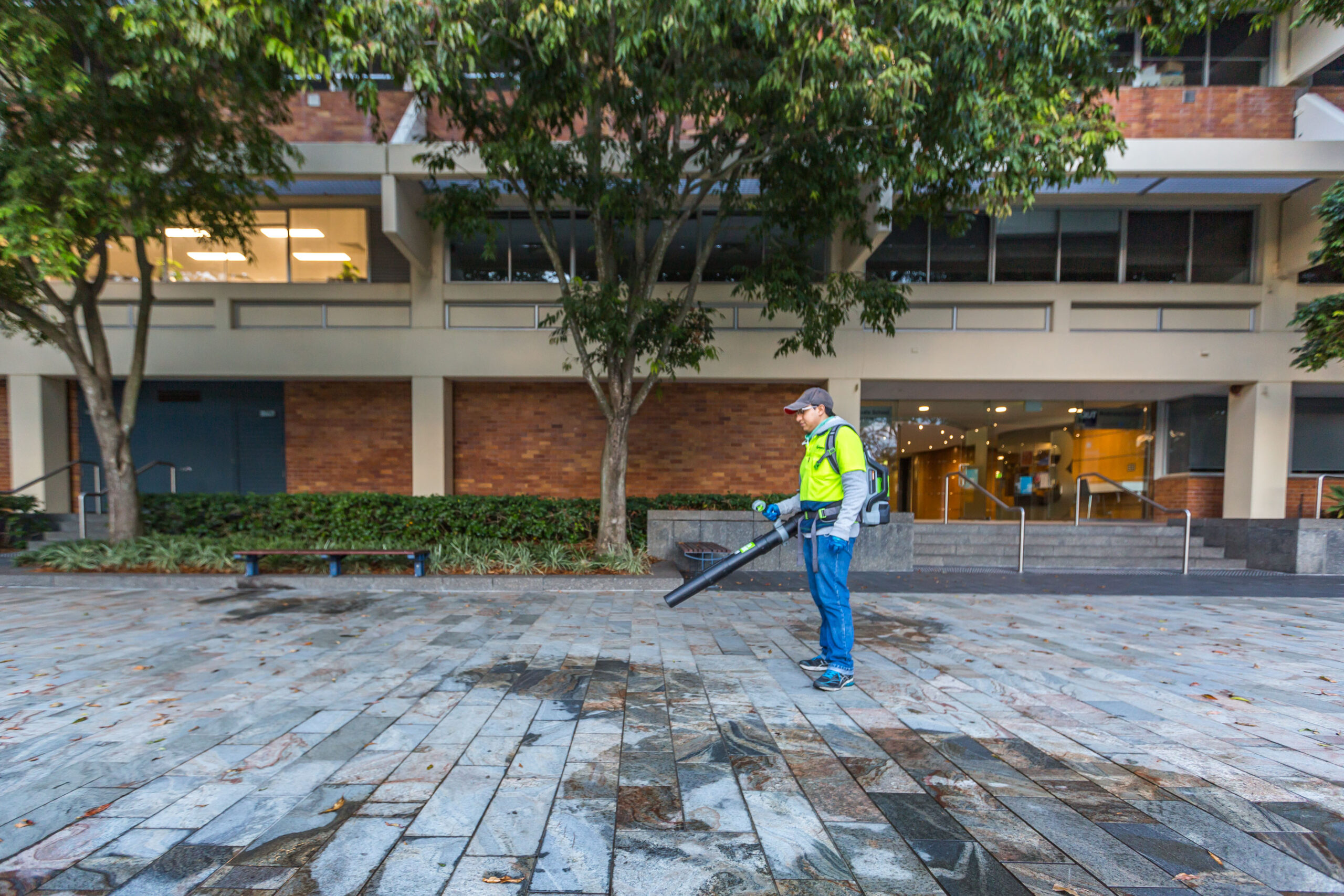 Man using blower on pavement Springmount Services Commercial