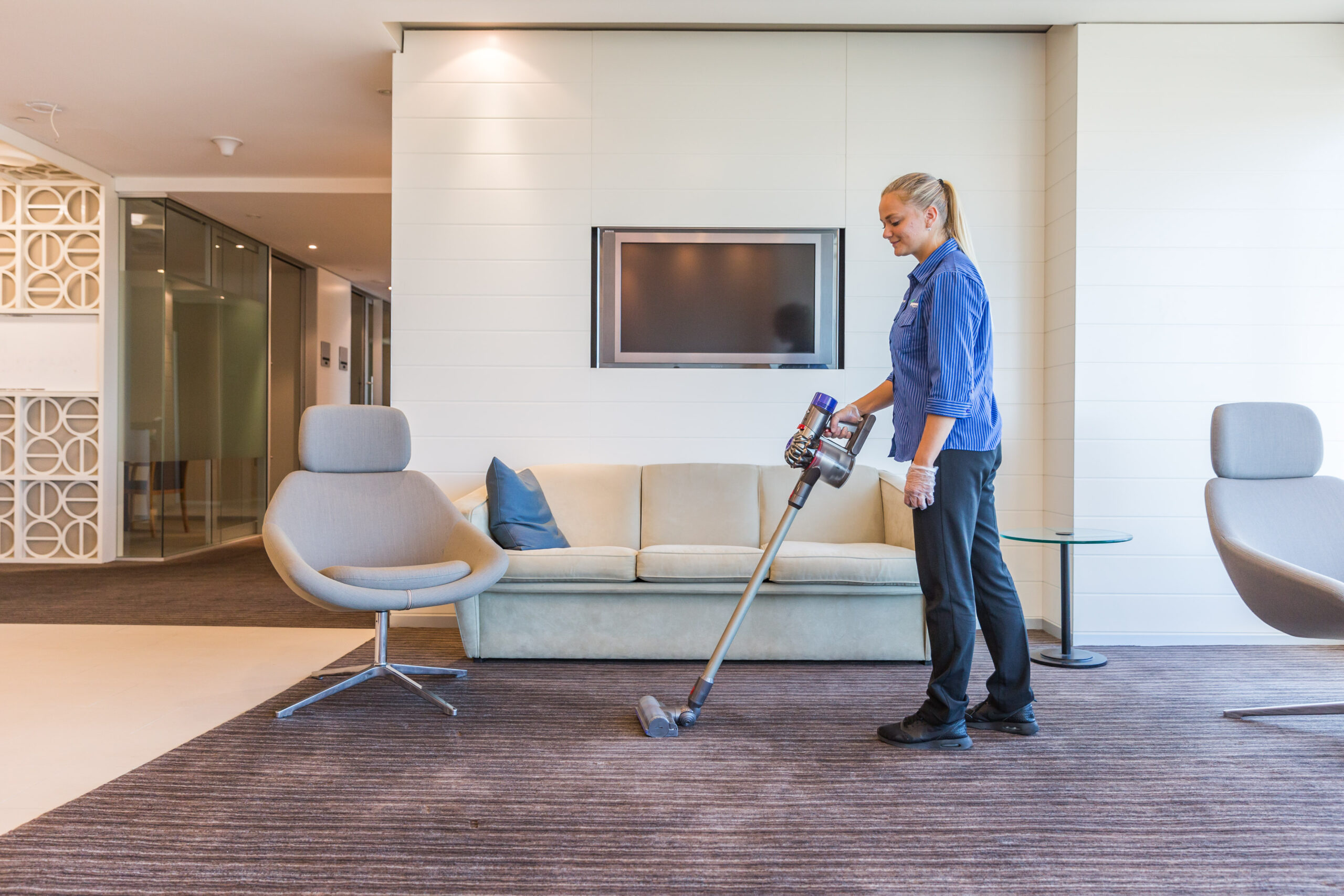 Female vacuuming office reception Springmount Services Commercial