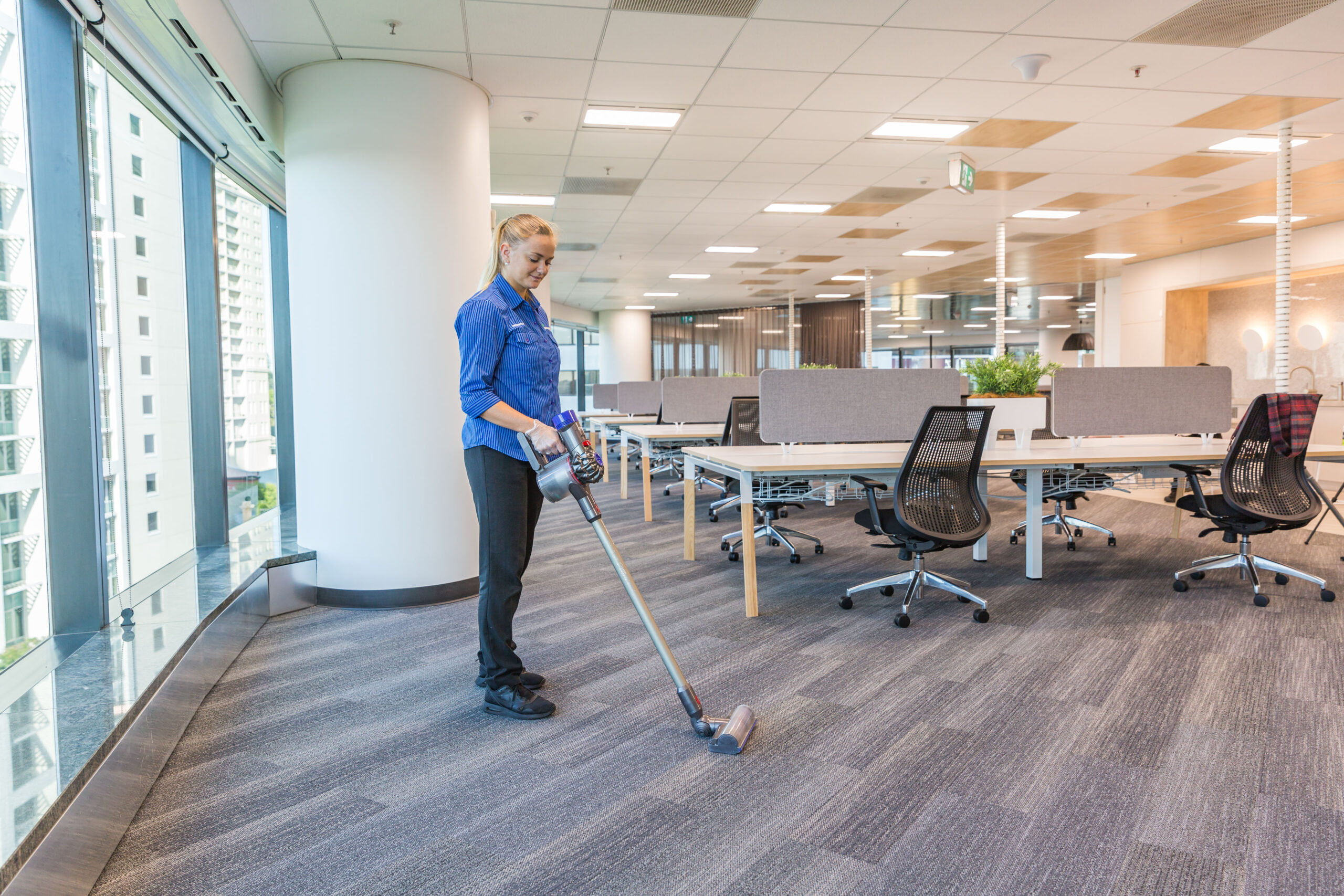Female Vacuuming office building Springmount Services Commercial