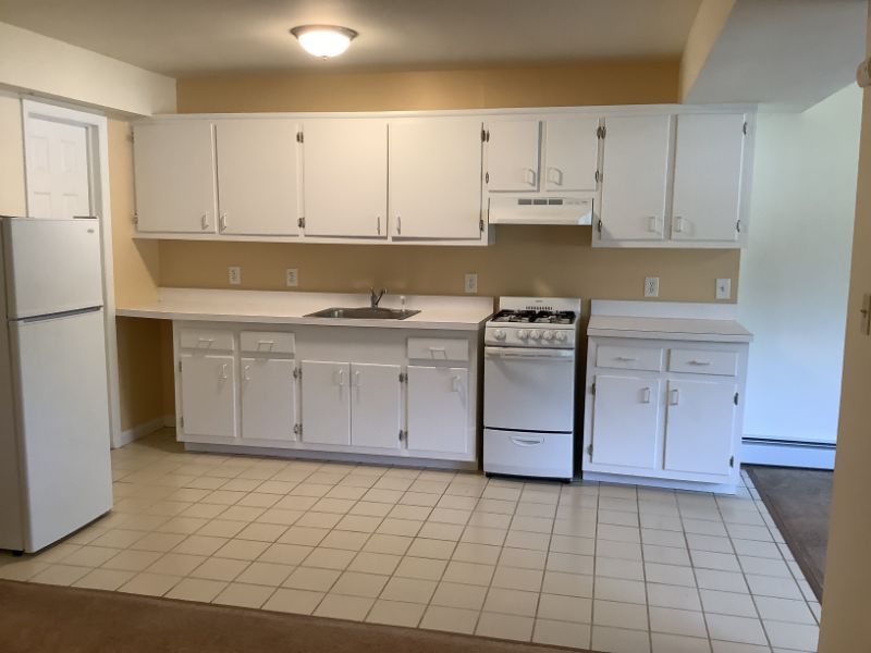Studio Type H kitchen with white appliances and cabinets.