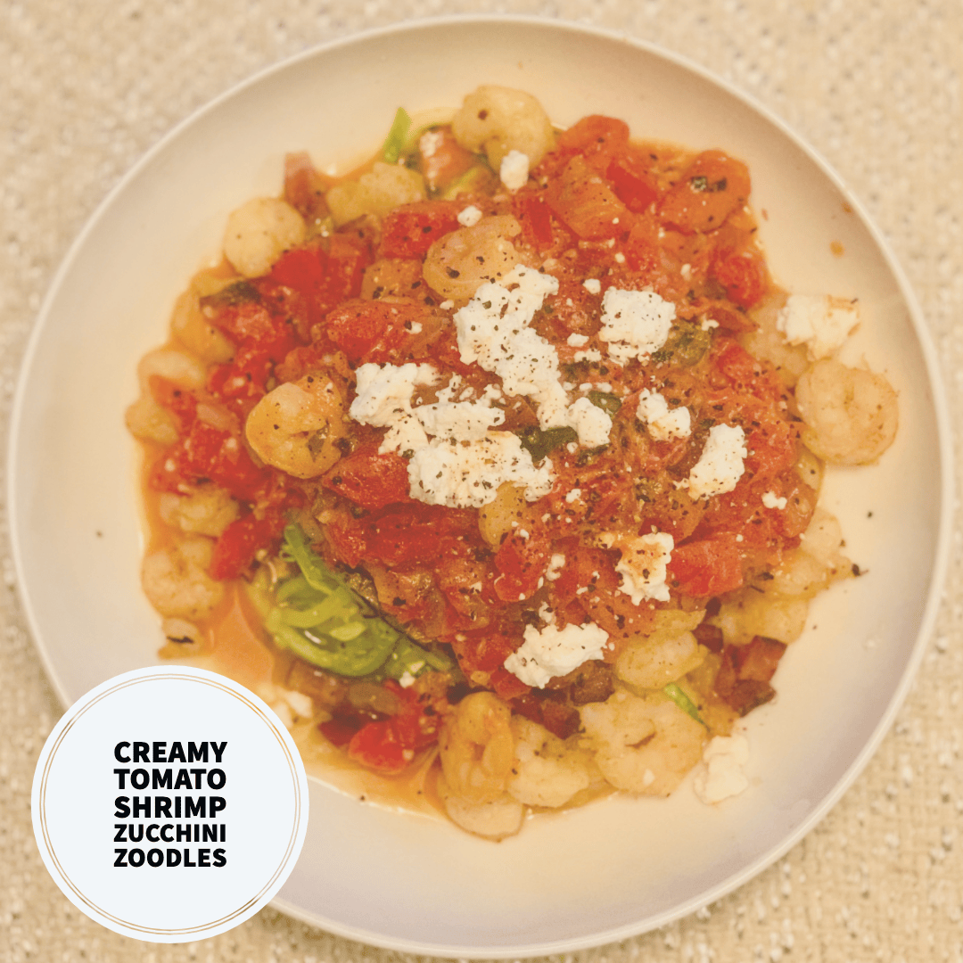 Dreamy photos of a bowl of creamy tomato sauce, shrimp, zucchini zoodles and crumbled cheese on top. Drool worthy photo! More incredible recipes to be found on www.sprouting-vitality.com #sproutingvitalityrecipes #kenzinthekitch #healthyhelpings