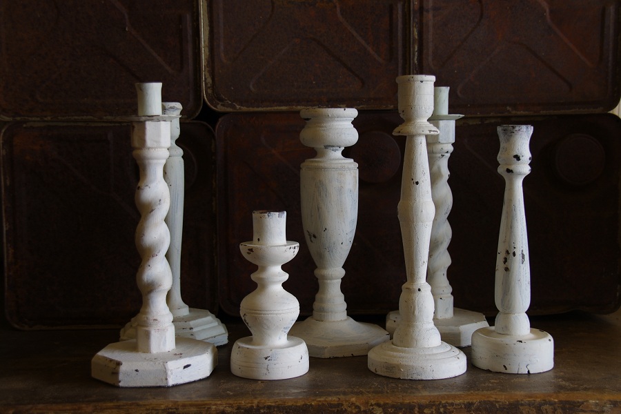 collection of metal and wooden candlestick holders Stalking Cat