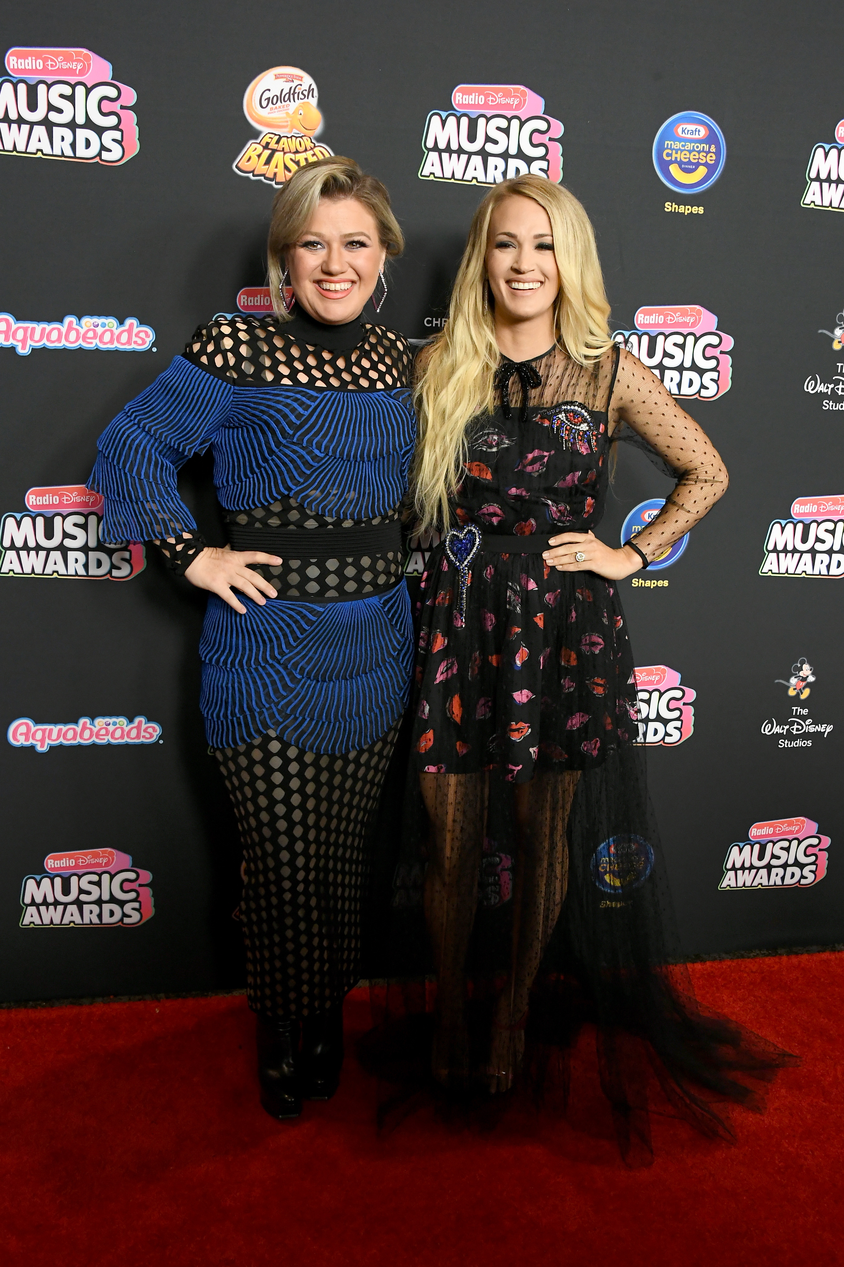 Kelly Clarkson and Carrie Underwood Have An 'American Idol' Reunion At 2018 Radio Disney Music