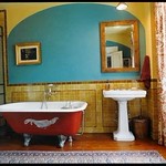 Colorful bathroom: Red tub + turquoise + gold