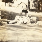 Baby on a blanket with his foot in the air