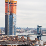 One Manhattan Square at 252 South Street (under construction) and Manhattan Bridge on the East River, New York City