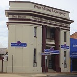 Wellington. Built for Commercial Bank of Sydney around 1910, now Stock Agent since 1985. On laneway with chamfered corners, recessed entrance with columns on each side, curved masonry balustrade on balcony.