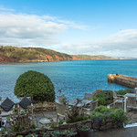 Devonian Old Red Sandstone cliffs from "The Cary Arms," Babbacombe Bay, with Teignmouth and Exmouth on the horizon, Torquay, Devon, England.