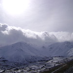 Clouds over snowy mountain