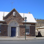 The old Bank of South Australia building in the Main Street of Moonta South Australia. Built in 1864 in local stone. Unusual gable entrance. Looks sort of modernised. The Moonta Mining Company banked here.