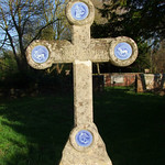 four enamel evangelist symbols on a headstone cross
