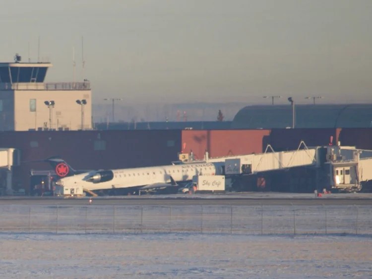 Catering truck gets stuck under Air Canada plane The