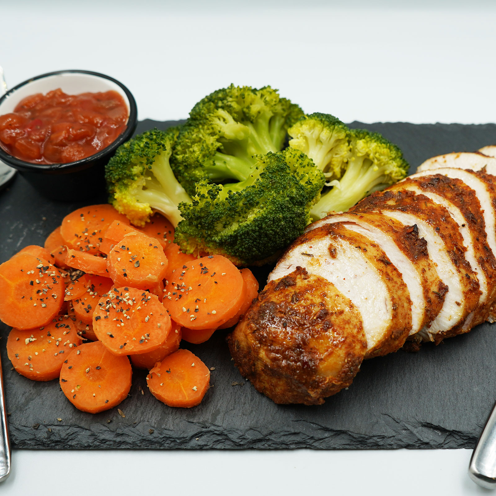 Grilled Cajun chicken breast with seasoned and steamed broccoli and
