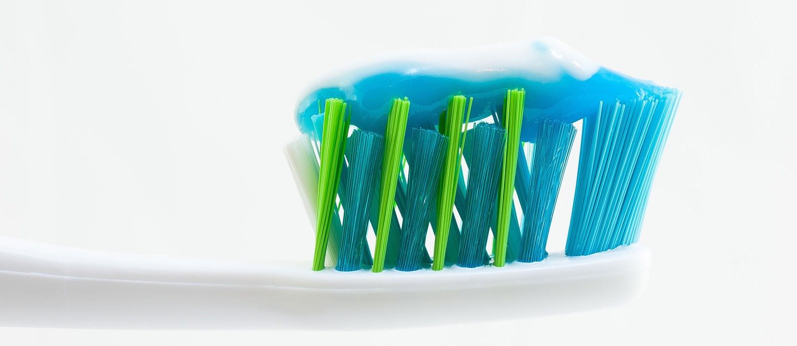 Which chemical compound is added to toothpaste to ensure strong teeth?